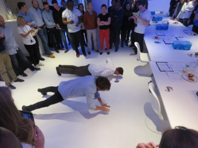 Two people doing push-ups at team building event for Red Nose Day