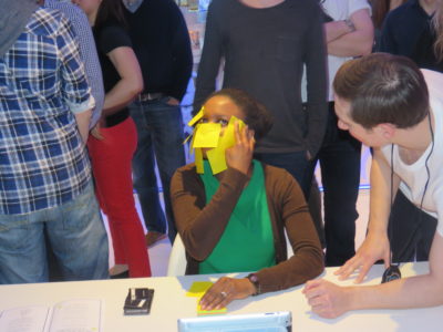 Lady playing sticky note game at team building event for Red Nose Day