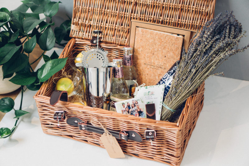 a hamper filled with flowers and gifts